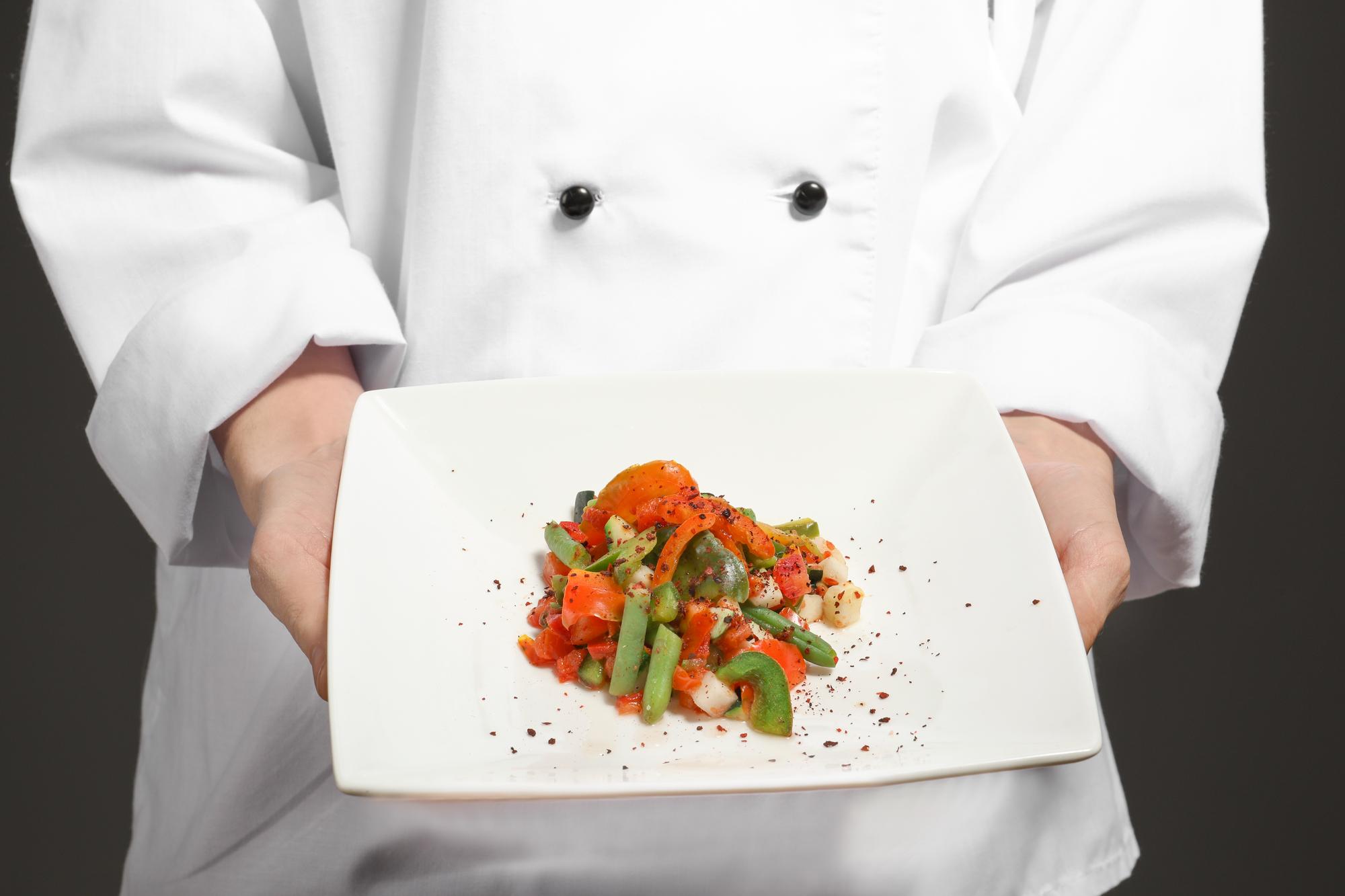 Instructor demonstrating plating in a modern kitchen